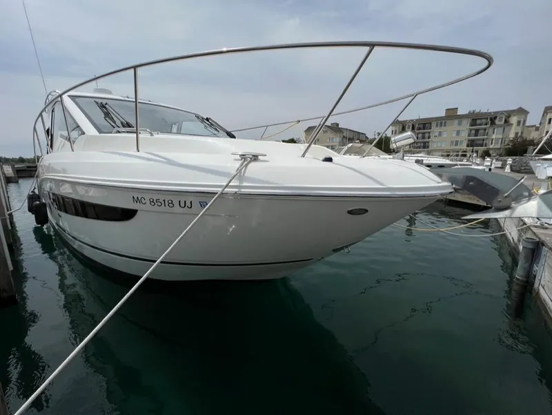 Slide: The Image of 2019 Sea Ray Sundancer 350 Coupe docked in marina, sleek design, calm water. - 4