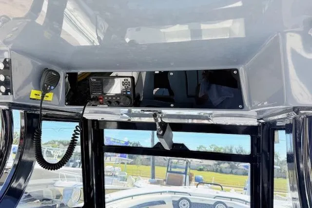 Slide: The Image of 2023 Tidewater 320 CC Adventure boat console with radio and microphone. - 10