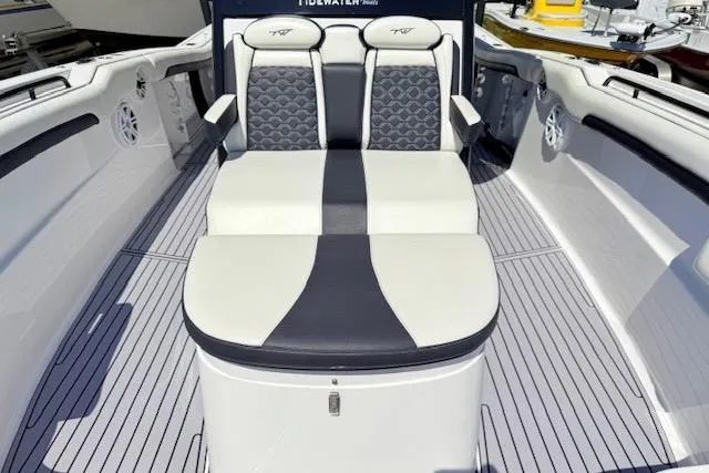 Slide: The Image of 2023 Tidewater 320 CC Adventure boat interior with cushioned seating and sleek design. - 13