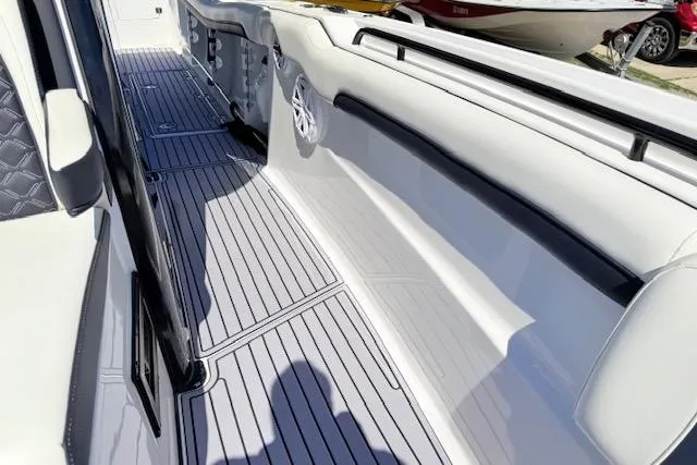 Slide: The Image of 2023 Tidewater 320 CC Adventure boat interior with sleek, modern design and spacious deck. - 15