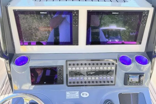 Slide: The Image of 2023 Tidewater 320 CC Adventure dashboard with dual Simrad displays and control panel. - 18