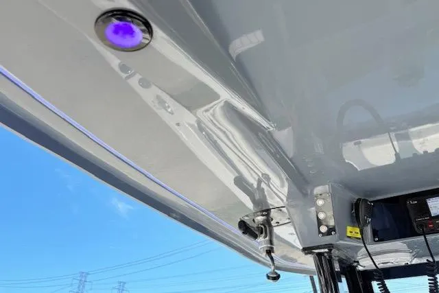 Slide: The Image of 2023 Tidewater 320 CC Adventure boat with modern lighting and equipment under a clear blue sky. - 19