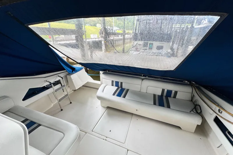 Slide: The Image of Interior of 1990 Sea Ray 350 Express Cruiser with blue and white seating. - 3