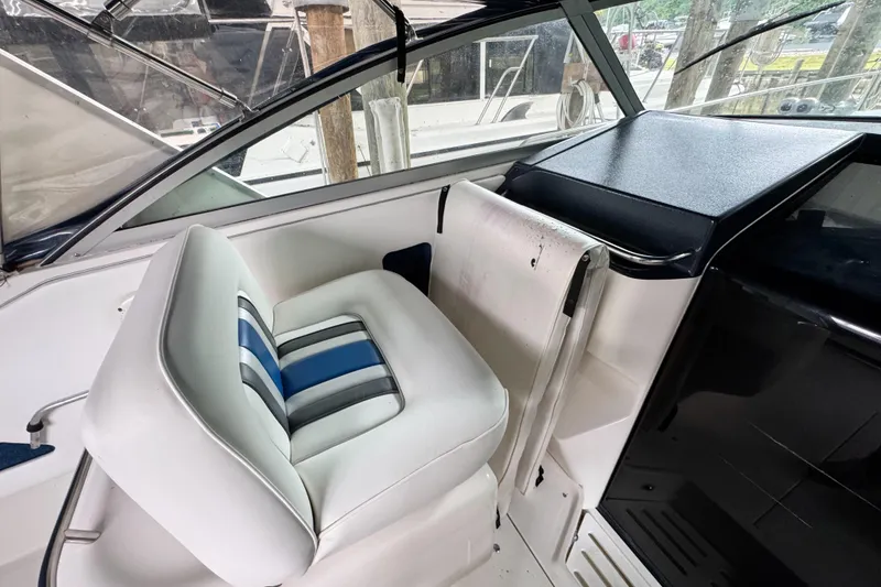 Slide: The Image of 1990 Sea Ray 350 Express Cruiser interior with white and blue seating. - 4