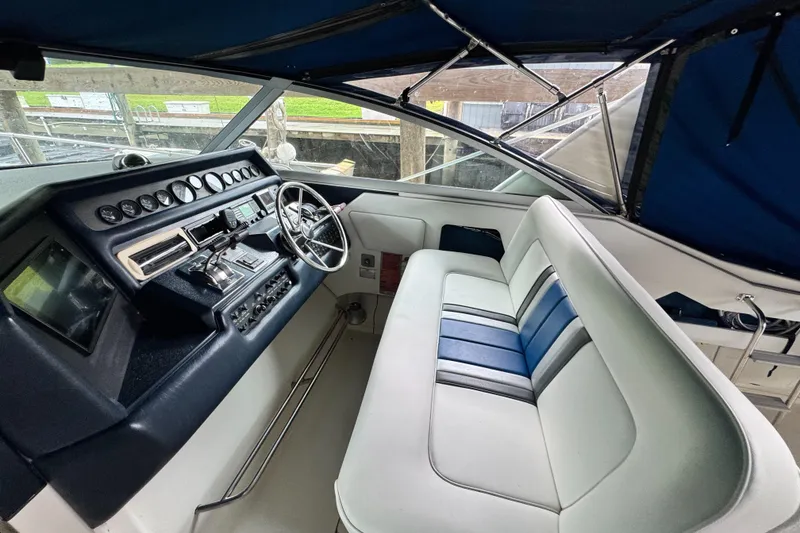 Slide: The Image of 1990 Sea Ray 350 Express Cruiser cockpit with steering wheel and seating. - 5