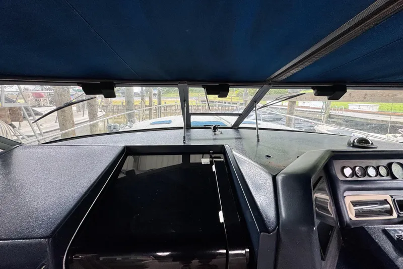 Slide: The Image of Interior view of 1990 Sea Ray 350 Express Cruiser cockpit with dashboard and controls. - 7