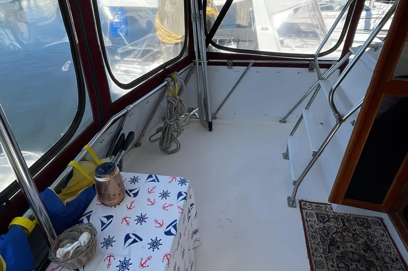 Slide: The Image of 1989 Jefferson 37 Sundeck yacht docked, surrounded by trees and parked cars. - 10