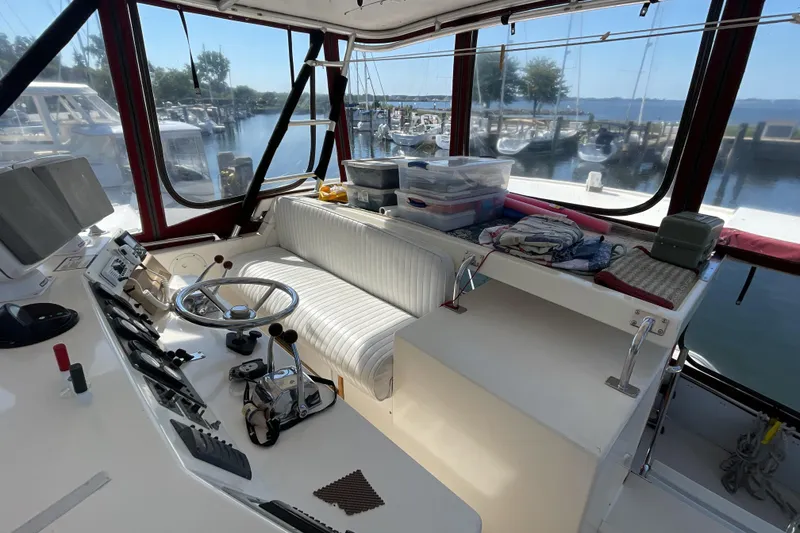 Slide: The Image of 1989 Jefferson 37 Sundeck interior with nautical-themed tablecloth and decor. - 15