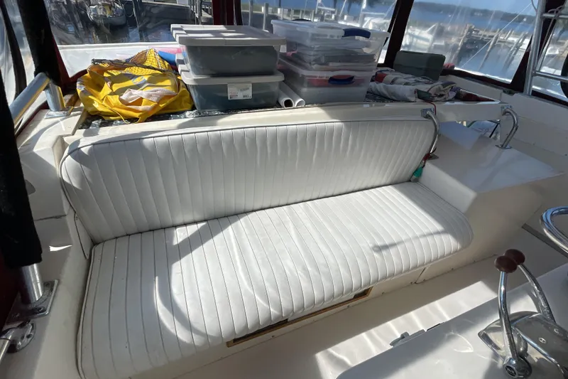 Slide: The Image of 1989 Jefferson 37 Sundeck interior with white seating and nautical-themed decor. - 16