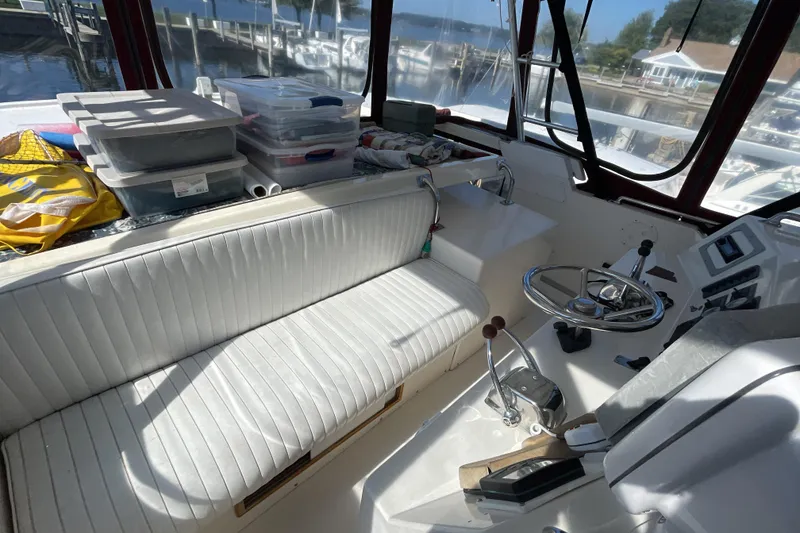 Slide: The Image of 1989 Jefferson 37 Sundeck boat helm with controls, gauges, and seating area. - 17