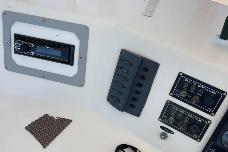 Slide: The Image of 1989 Jefferson 37 Sundeck boat interior with white seating and storage boxes. - 19