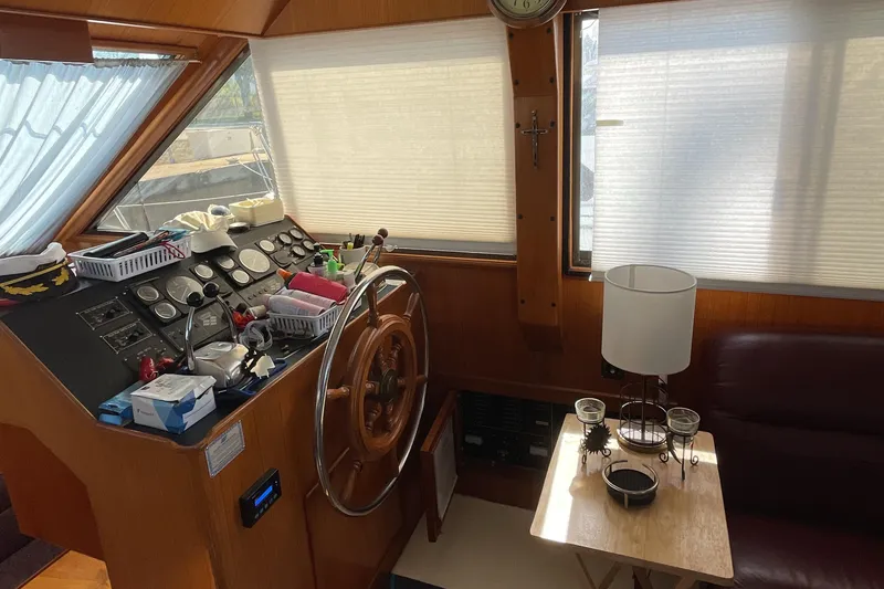 Slide: The Image of Interior of 1989 Jefferson 37 Sundeck boat with red and white seating, docked by the water. - 26