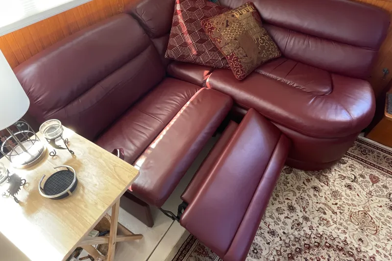 Slide: The Image of Interior of 1989 Jefferson 37 Sundeck with maroon leather seating and nautical decor. - 30