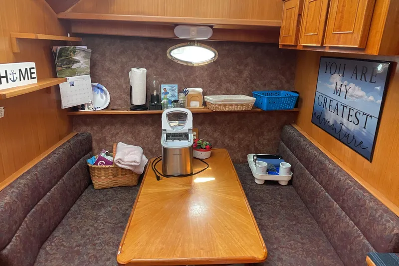 Slide: The Image of Cozy dining area in 1989 Jefferson 37 Sundeck with wood accents and adventure-themed decor. - 33