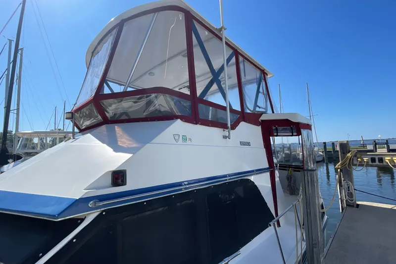 Slide: The Image of Cozy bedroom in 1989 Jefferson 37 Sundeck yacht with plaid bedding and wood paneling. - 4