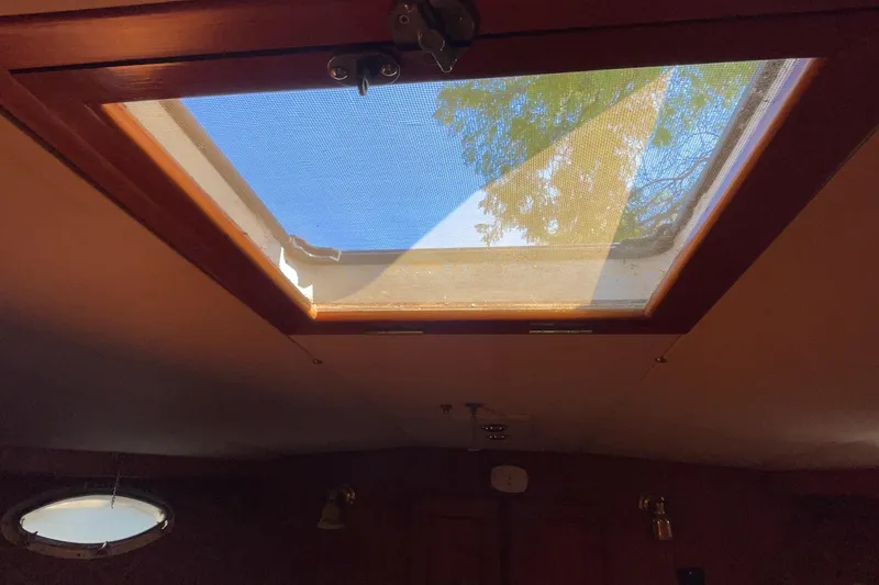 Slide: The Image of Cozy cabin interior of 1989 Jefferson 37 Sundeck with striped bedding and wooden cabinetry. - 42