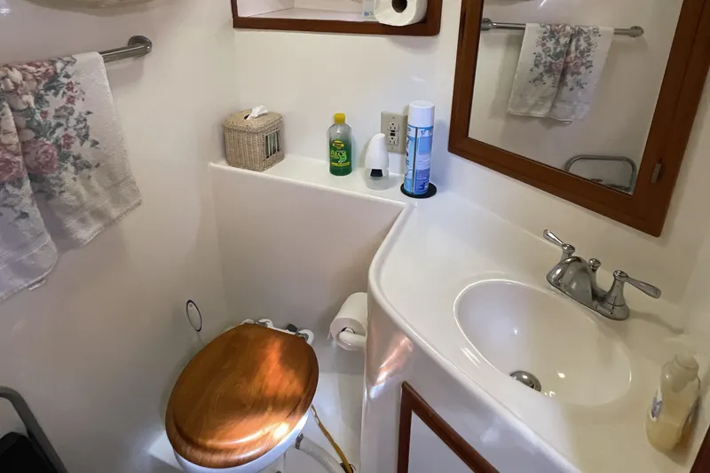 Slide: The Image of Bathroom interior of 1989 Jefferson 37 Sundeck yacht with wooden accents and toiletries. - 44