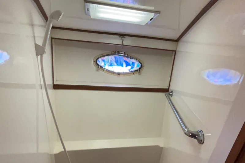 Slide: The Image of Shower area in 1989 Jefferson 37 Sundeck yacht with porthole and grab bar. - 46