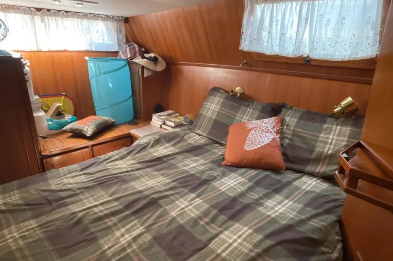 Slide: The Image of Cozy bedroom in 1989 Jefferson 37 Sundeck yacht with plaid bedding and wooden interior. - 48