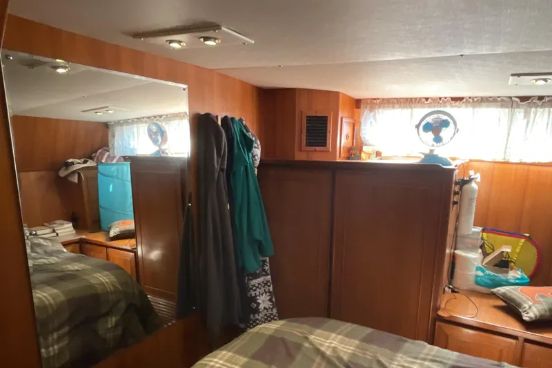 Slide: The Image of Cozy interior of 1989 Jefferson 37 Sundeck yacht with wood paneling and personal items. - 49