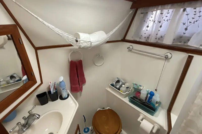 Slide: The Image of Bathroom interior of 1989 Jefferson 37 Sundeck yacht with toiletries and wooden accents. - 50