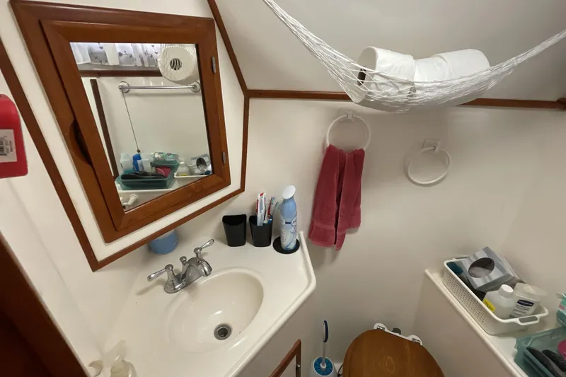 Slide: The Image of 1989 Jefferson 37 Sundeck bathroom with sink, mirror, and storage. - 51