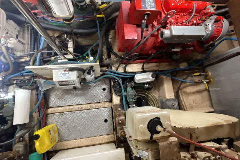 Slide: The Image of Engine room of a 1989 Jefferson 37 Sundeck boat with visible machinery and wiring. - 55