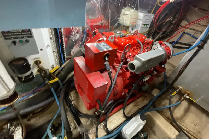 Slide: The Image of Engine room of 1989 Jefferson 37 Sundeck with red machinery and wiring. - 56