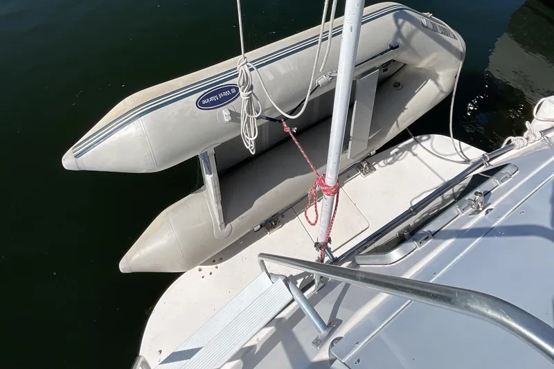 Slide: The Image of 1989 Jefferson 37 Sundeck yacht docked at marina under clear blue sky. - 9