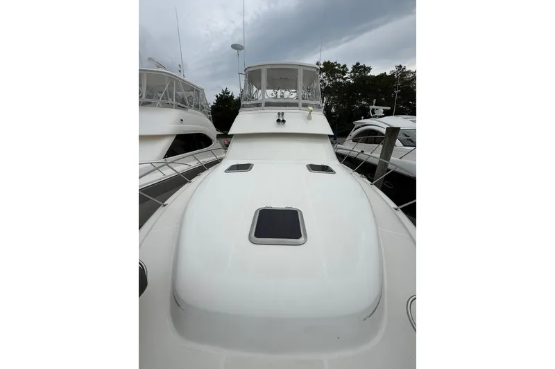 Slide: The Image of 1991 Tiara Yachts 4300 Convertible, white exterior, docked with overcast sky. - 12