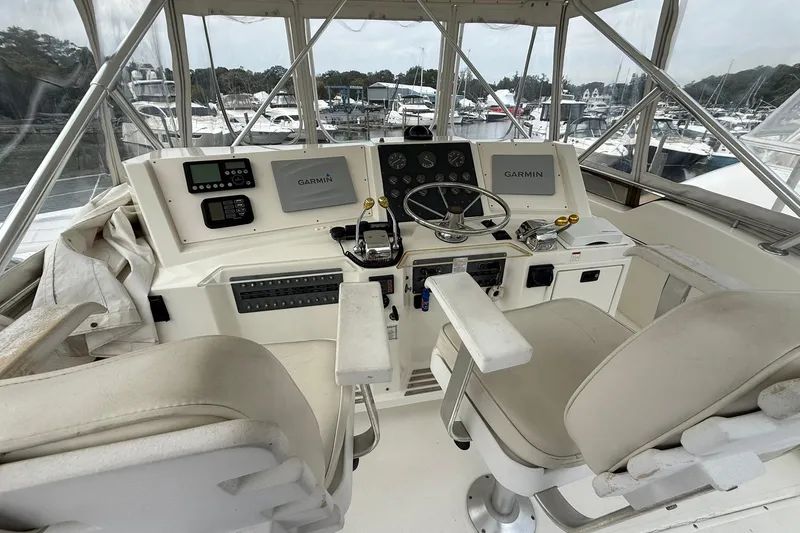 Slide: The Image of Helm of 1991 Tiara Yachts 4300 Convertible with Garmin navigation system, marina view. - 18