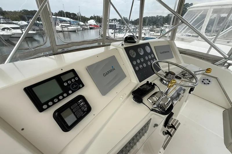 Slide: The Image of Helm of 1991 Tiara Yachts 4300 Convertible with Garmin navigation system and steering wheel. - 20