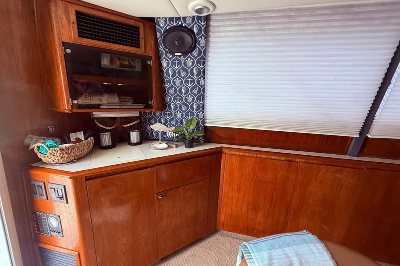 Slide: The Image of 1991 Tiara Yachts 4300 Convertible interior with wood cabinetry and nautical decor. - 23