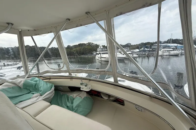 Slide: The Image of Interior view of 1991 Tiara Yachts 4300 Convertible at marina, showcasing comfortable seating. - 25