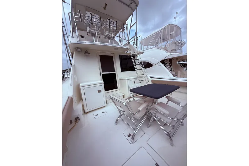 Slide: The Image of 1991 Tiara Yachts 4300 Convertible with outdoor seating and ladder to upper deck. - 27
