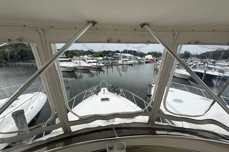 Slide: The Image of 1991 Tiara Yachts 4300 Convertible in marina, surrounded by other boats. - 31