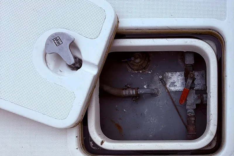 Slide: The Image of Access hatch of a 1991 Tiara Yachts 4300 Convertible, showing internal components. - 32