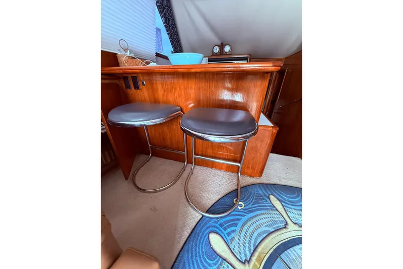 Slide: The Image of Interior of 1991 Tiara Yachts 4300 Convertible with bar stools and nautical decor. - 36