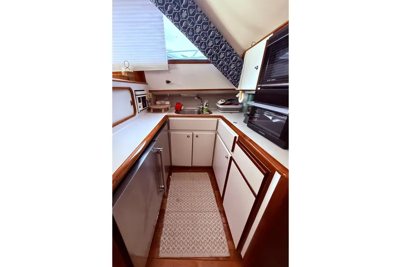Slide: The Image of 1991 Tiara Yachts 4300 Convertible kitchen with modern appliances and sleek cabinetry. - 38