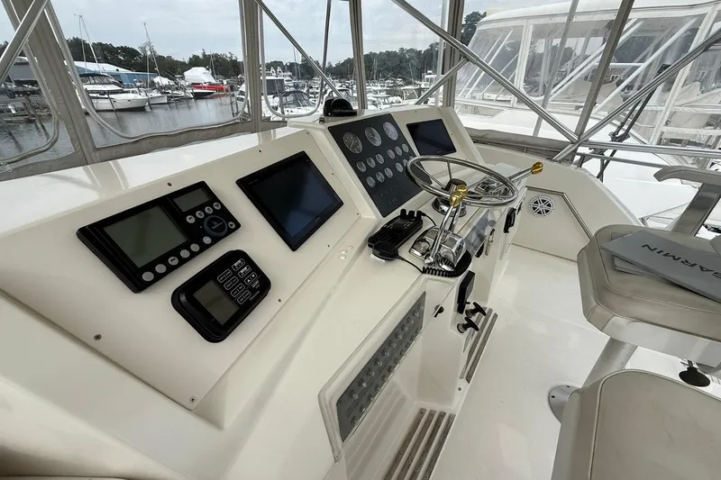 Slide: The Image of 1991 Tiara Yachts 4300 Convertible helm with modern navigation equipment and steering wheel. - 39