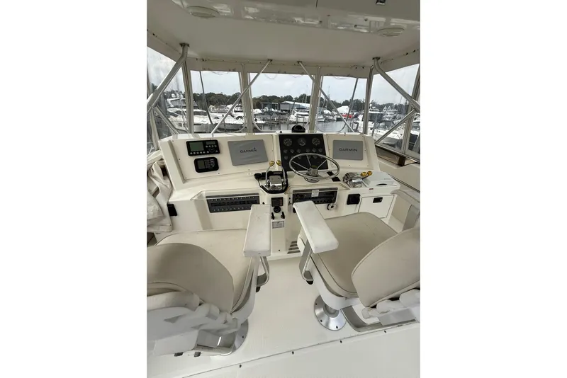 Slide: The Image of 1991 Tiara Yachts 4300 Convertible helm with Garmin navigation, dual seats, and control panel. - 40