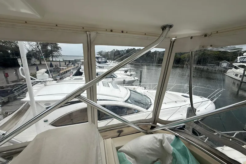 Slide: The Image of 1991 Tiara Yachts 4300 Convertible docked at a marina, view from cabin. - 42