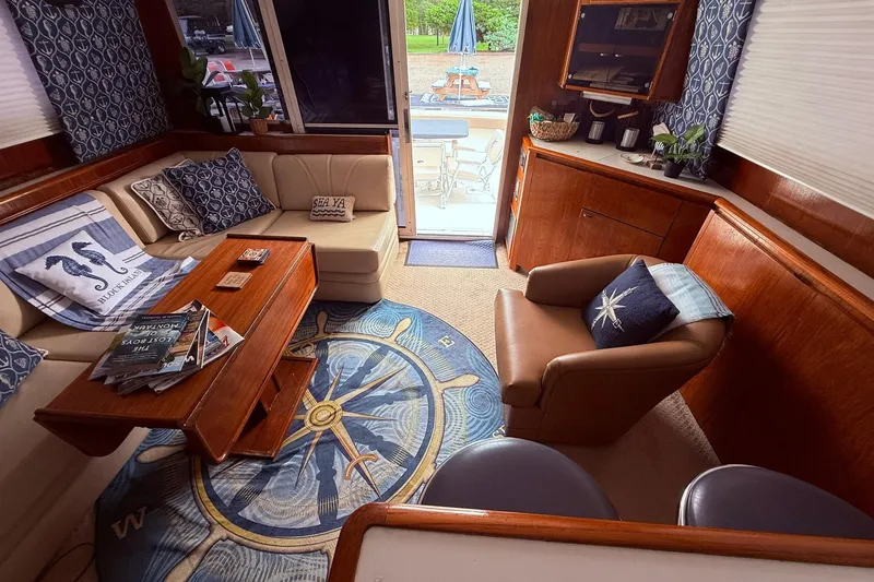 Slide: The Image of Luxurious interior of a 1991 Tiara Yachts 4300 Convertible, featuring nautical decor and comfortable seating. - 54
