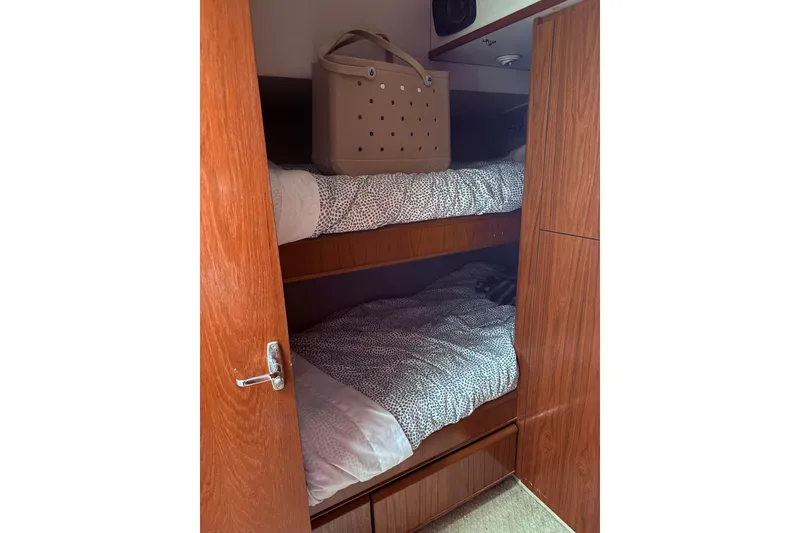 Slide: The Image of Bunk beds in 1991 Tiara Yachts 4300 Convertible cabin with wooden interior. - 55