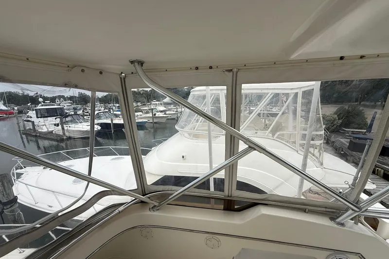 Slide: The Image of 1991 Tiara Yachts 4300 Convertible docked at marina, view from cabin. - 57