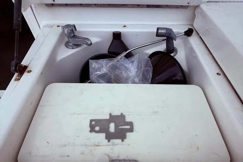 Slide: The Image of Storage compartment on a 1991 Tiara Yachts 4300 Convertible, containing tools and accessories. - 6