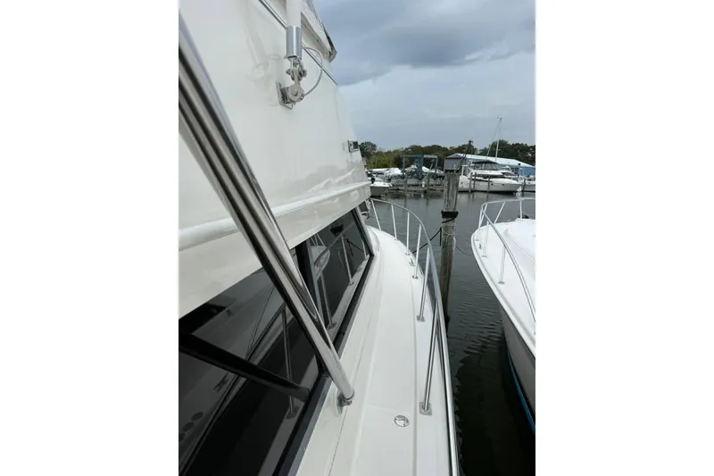 Slide: The Image of 1991 Tiara Yachts 4300 Convertible docked, showcasing sleek design and marina setting. - 62