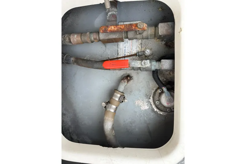 Slide: The Image of Engine compartment of a 1991 Tiara Yachts 4300 Convertible with visible pipes and valves. - 71