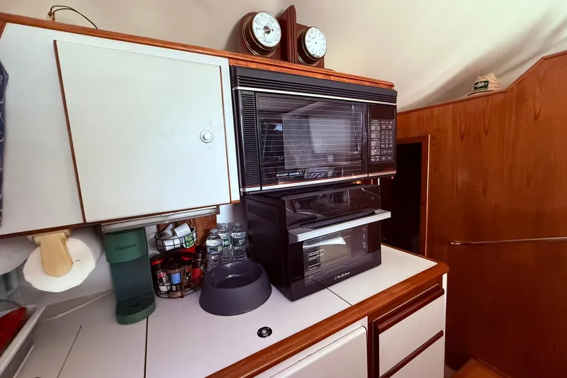Slide: The Image of 1991 Tiara Yachts 4300 Convertible kitchen with microwave, oven, and storage cabinets. - 72