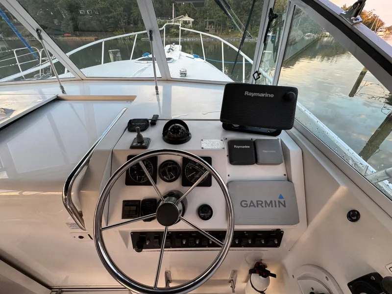Slide: The Image of 1999 Mainship Pilot 30 Sedan helm with Garmin and Raymarine navigation systems. - 11